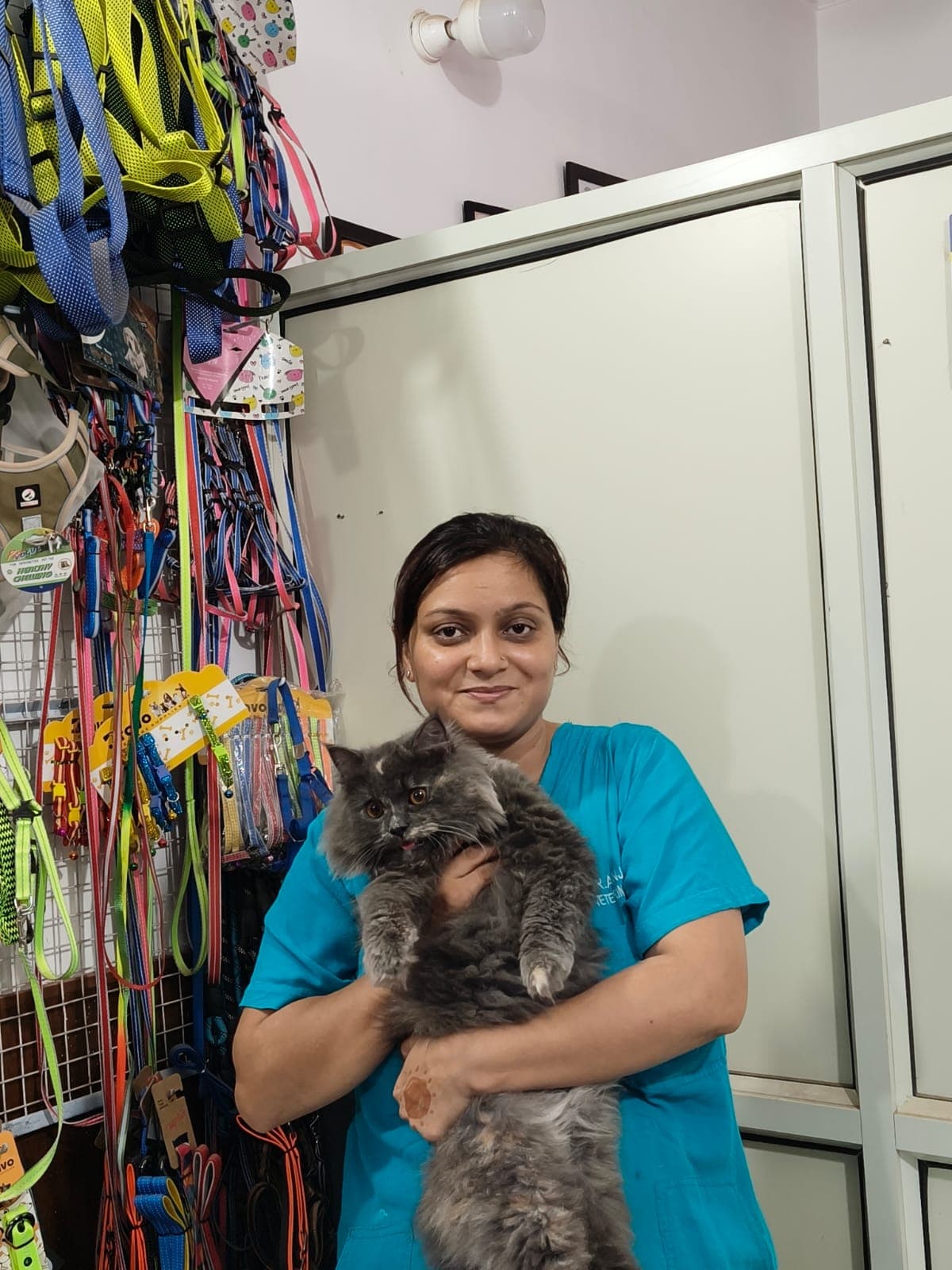 Dr. Anjali Negi smiling while holding a patient cat